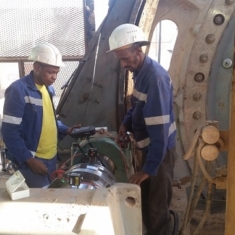 Maintenance personnel from Ariab Mining performing laser alignment on a drive train after being trained.